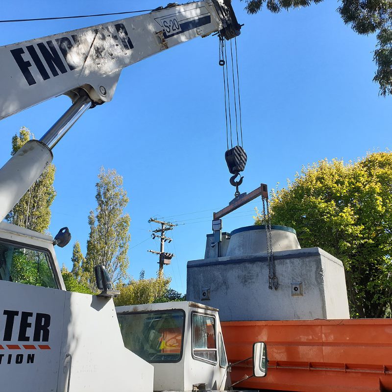 crane lifting wastewater tank